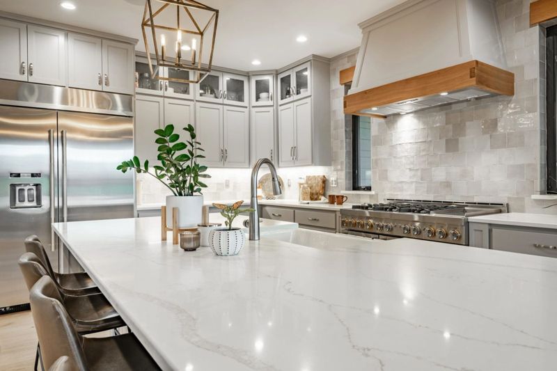 Bright modern kitchen with white quartz countertops and a large island